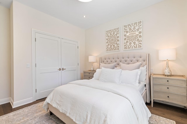 bedroom featuring a closet and dark hardwood / wood-style flooring