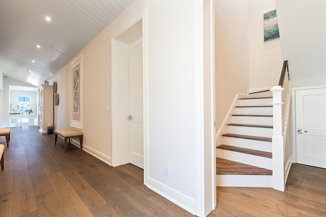 staircase featuring hardwood / wood-style floors and vaulted ceiling