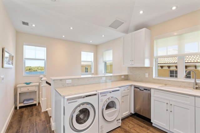 laundry room with dark hardwood / wood-style flooring, washing machine and dryer, and sink