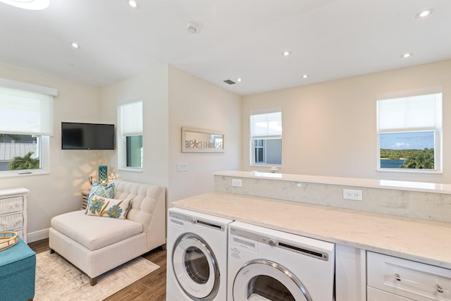 laundry room featuring separate washer and dryer, light wood-type flooring, and plenty of natural light