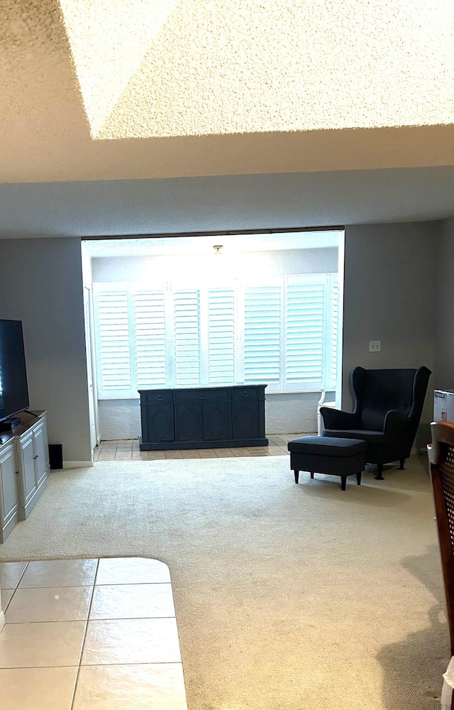 living room featuring a wealth of natural light and light colored carpet