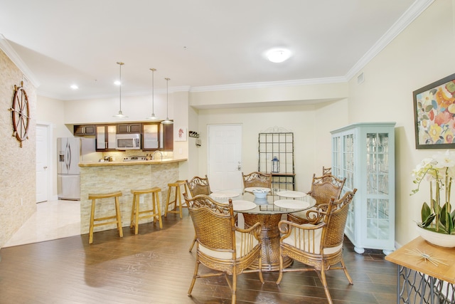 dining space with ornamental molding, dark wood-style flooring, and visible vents