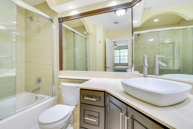 full bathroom featuring shower / bath combination with glass door, vanity, toilet, and tile patterned flooring