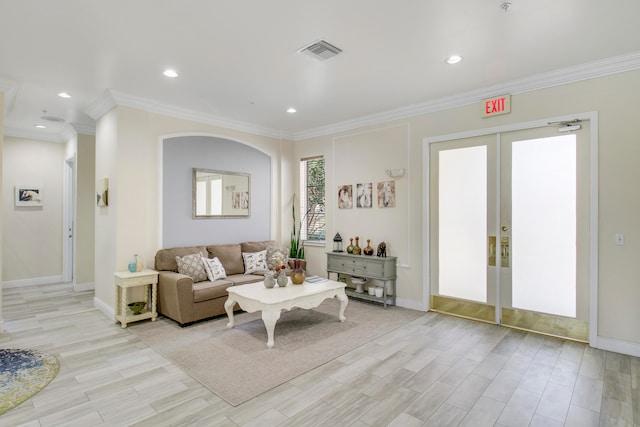 living room with ornamental molding, french doors, and light hardwood / wood-style flooring