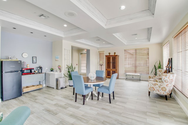 dining space featuring light wood-type flooring, coffered ceiling, and ornamental molding