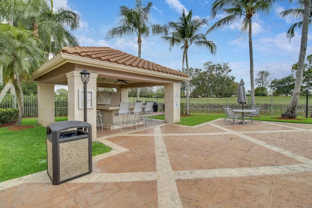 view of patio / terrace featuring ceiling fan, an outdoor kitchen, and a gazebo