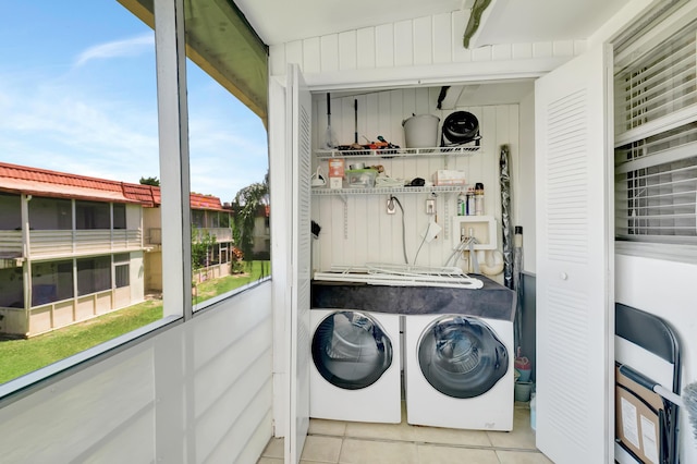 laundry room with tile patterned flooring, laundry area, and separate washer and dryer