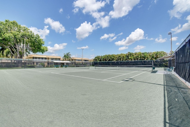 view of tennis court with fence