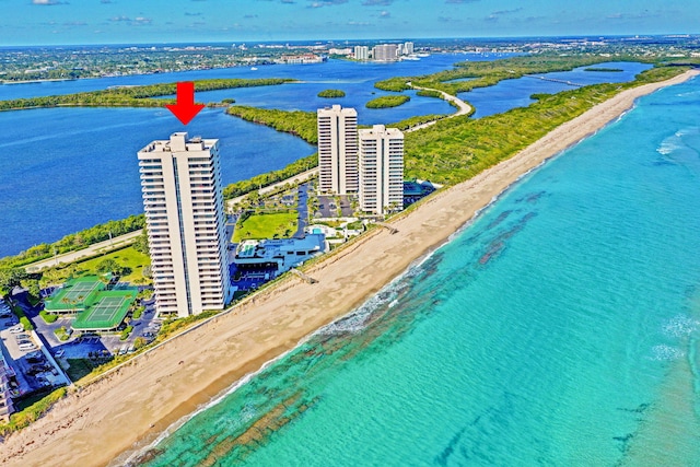 birds eye view of property with a beach view and a water view