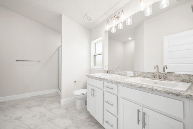 bathroom featuring an enclosed shower, vanity, and toilet