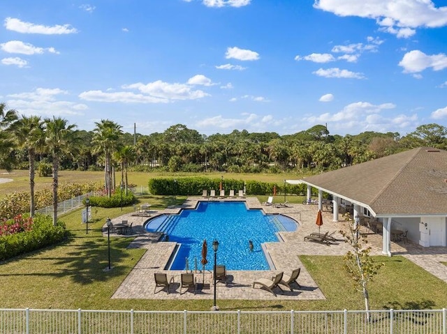 view of pool featuring a lawn and a patio area