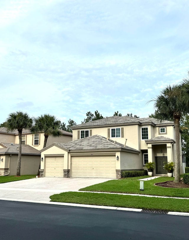 view of front of house featuring a garage and a front lawn