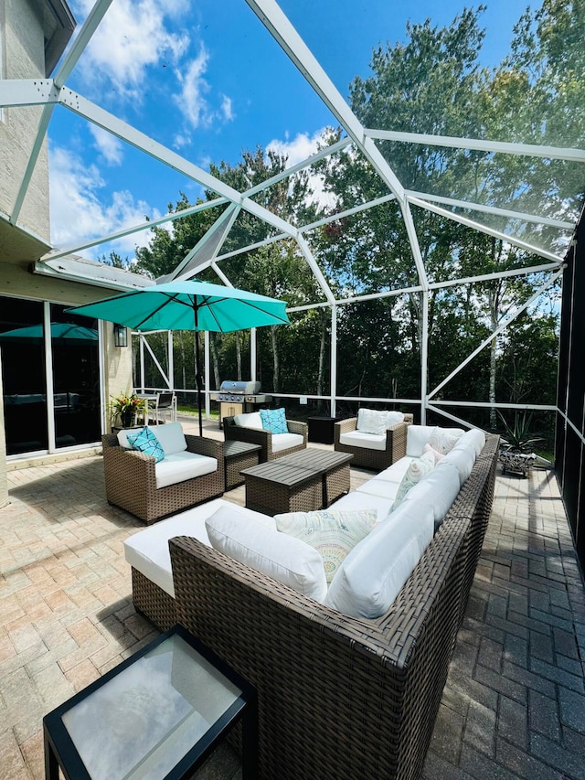 view of patio with grilling area, an outdoor living space, and glass enclosure