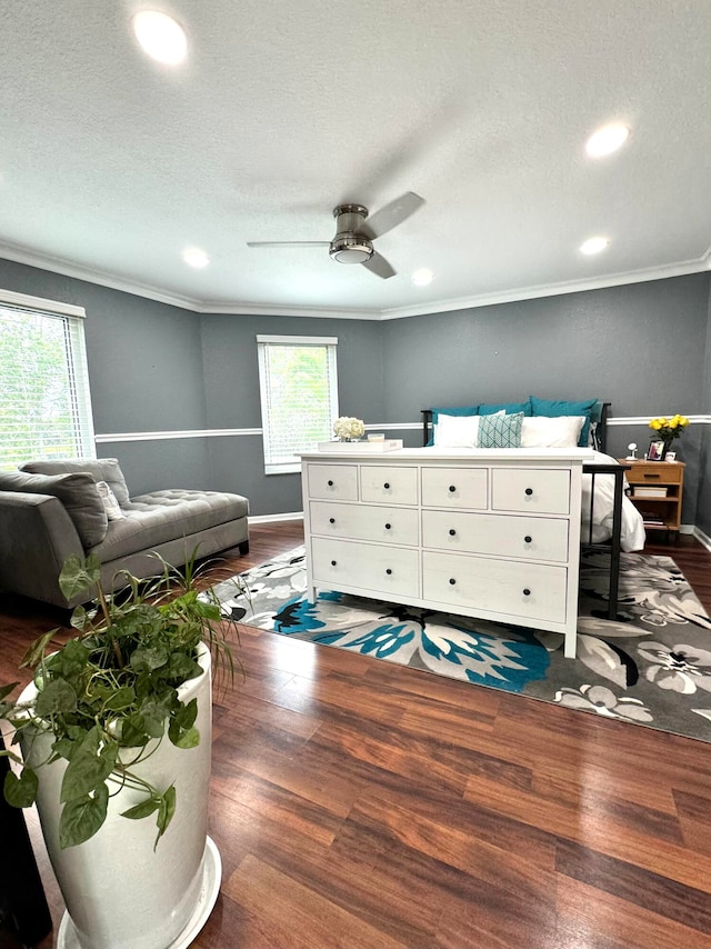 interior space featuring ceiling fan, dark hardwood / wood-style flooring, and crown molding