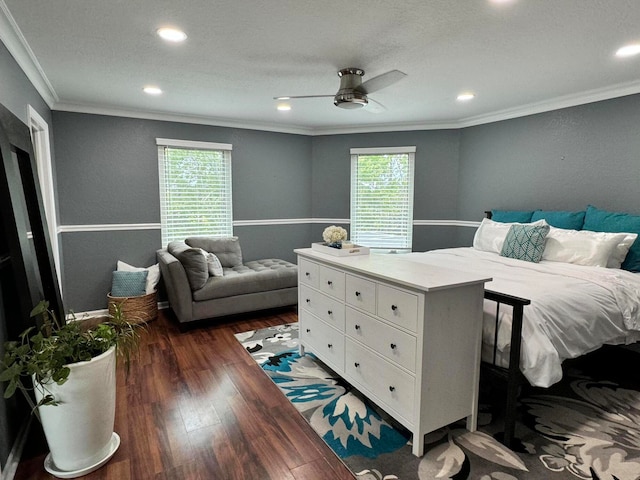 bedroom featuring ornamental molding, multiple windows, dark hardwood / wood-style flooring, and ceiling fan