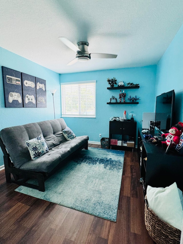 living room with ceiling fan, dark hardwood / wood-style floors, and a textured ceiling