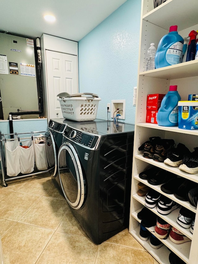 washroom featuring independent washer and dryer and light tile patterned flooring