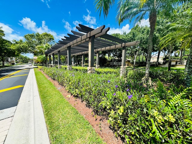 view of property's community featuring a water view and a pergola