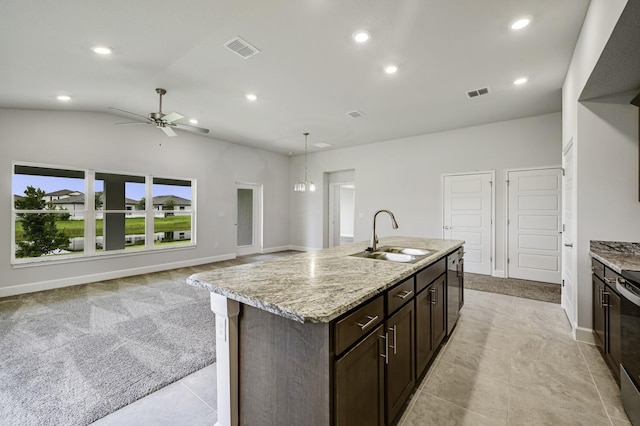 5175 Modeno St, Fort Pierce, FL 34951 - kitchen with a sink, dark brown cabinetry, a center island with sink, a ceiling fan, and recessed lighting