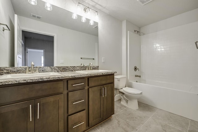 5175 Modeno St, Fort Pierce, FL 34951 - bathroom featuring toilet, double vanity, tile patterned floors, and bathing tub / shower combination