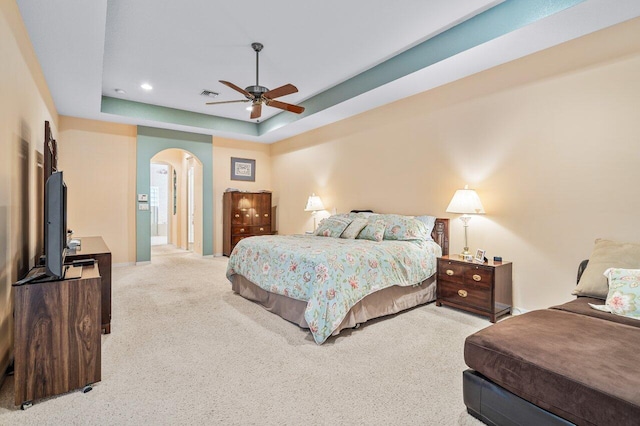 bedroom with carpet, ceiling fan, and a tray ceiling