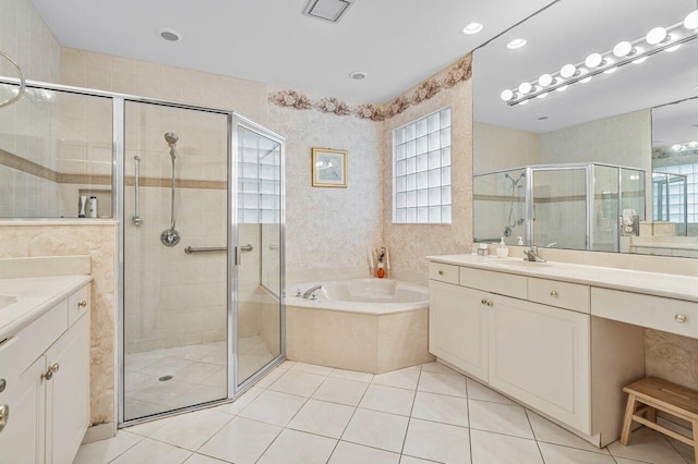 bathroom with plus walk in shower, tile patterned flooring, and vanity