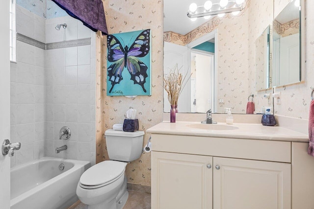 full bathroom featuring vanity, toilet, and tiled shower / bath combo