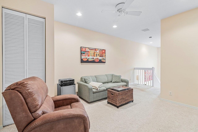 carpeted living room featuring ceiling fan