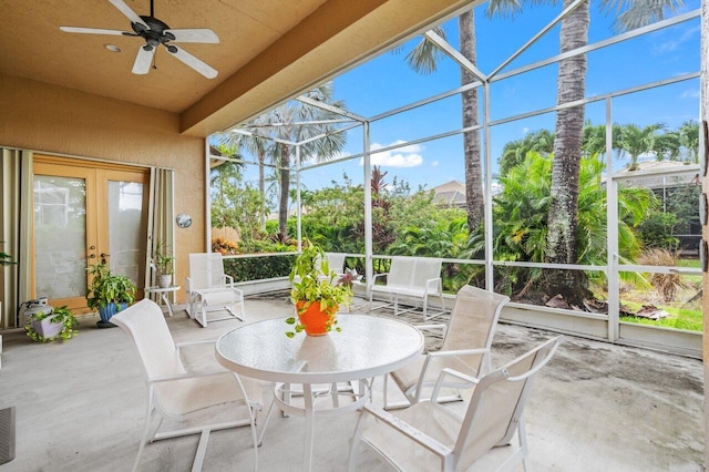 sunroom featuring ceiling fan and french doors