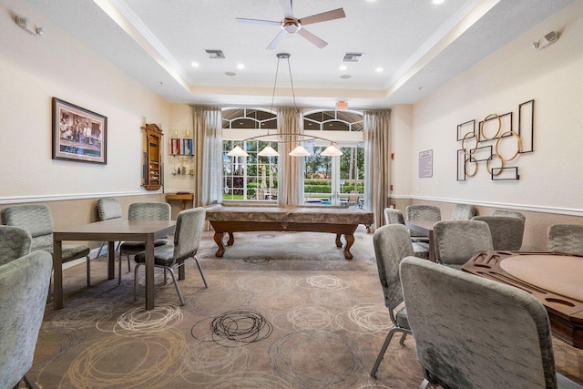 game room featuring a tray ceiling, pool table, a textured ceiling, and ceiling fan