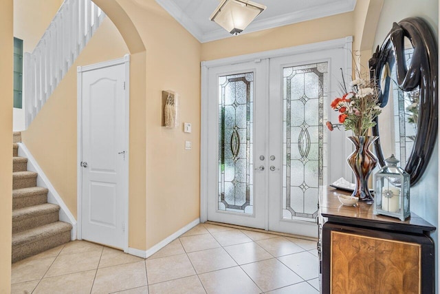 entryway with a wealth of natural light, crown molding, and french doors