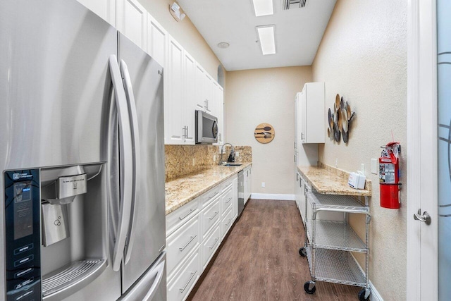 kitchen with stainless steel appliances, dark hardwood / wood-style flooring, white cabinetry, and sink