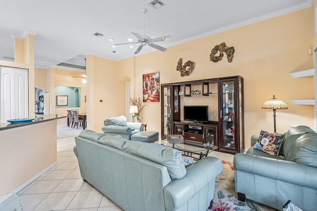 tiled living room featuring ceiling fan and ornamental molding