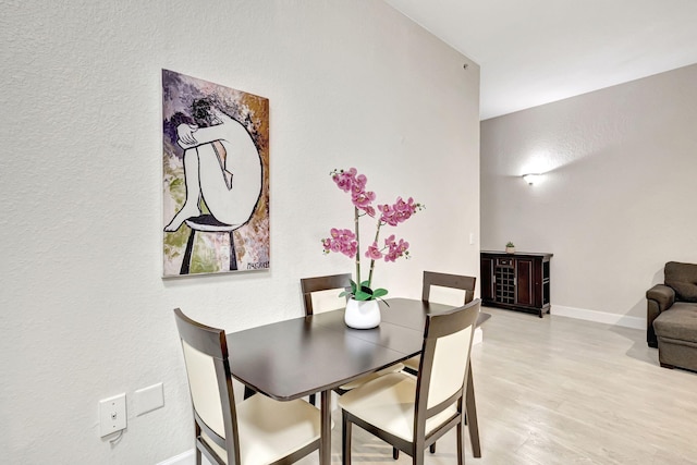 2801 Riverside Dr Unit 203-S, Coral Springs, FL 33065 - dining room with baseboards, light wood finished floors, and a textured wall