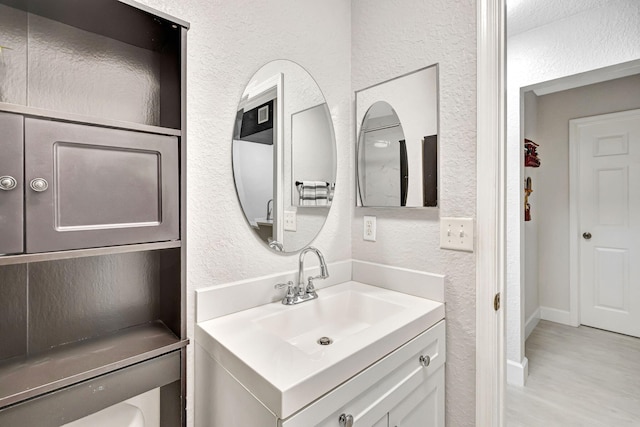 bathroom with vanity and hardwood / wood-style floors