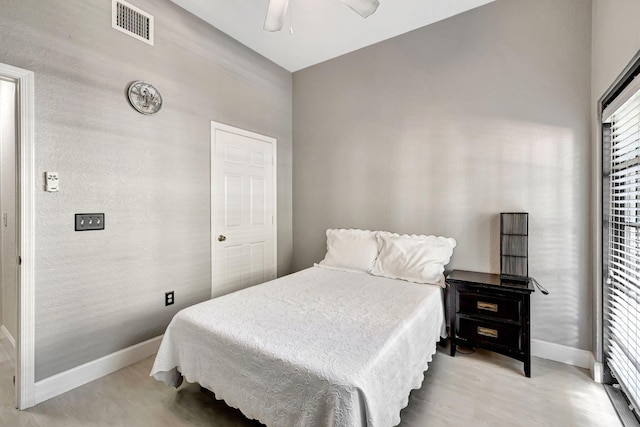 bedroom with light hardwood / wood-style floors and ceiling fan