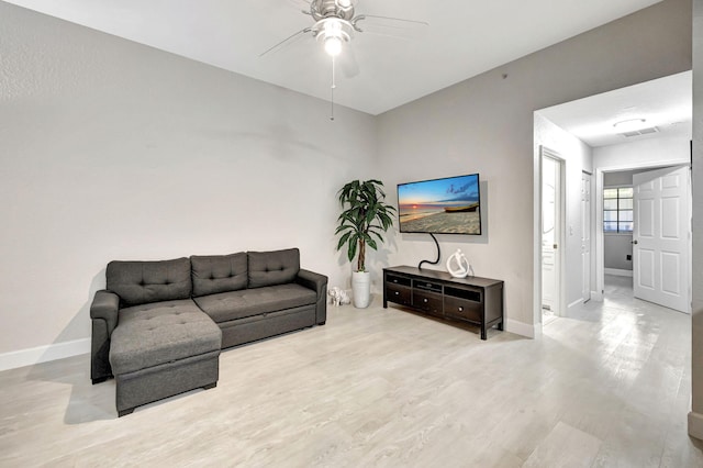 living room featuring ceiling fan and light wood-type flooring