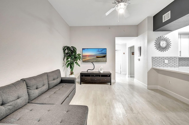 living room featuring light hardwood / wood-style flooring and ceiling fan