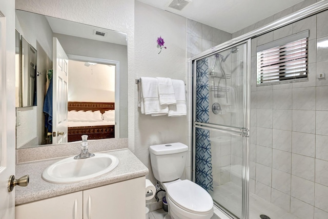 2801 Riverside Dr Unit 203-S, Coral Springs, FL 33065 - ensuite bathroom featuring a stall shower, toilet, vanity, and a textured wall