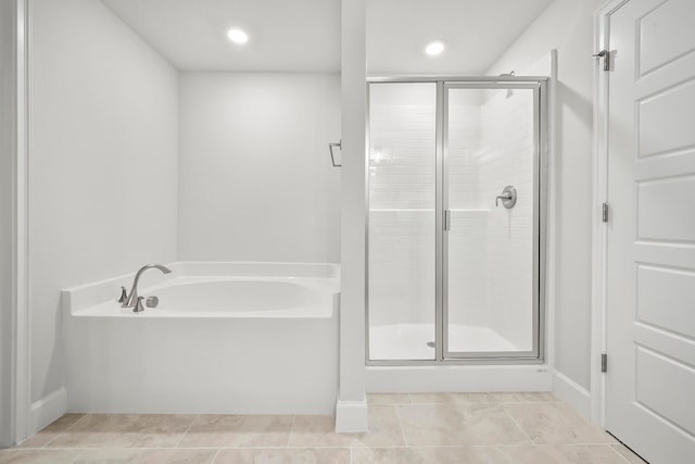 bathroom with tile patterned floors and plus walk in shower