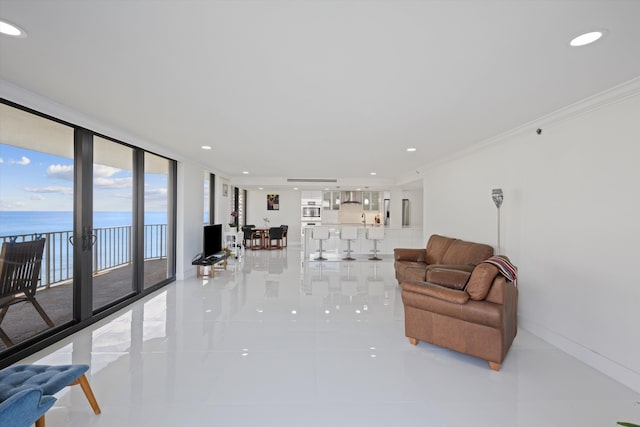 living room featuring expansive windows, tile patterned floors, a water view, and ornamental molding