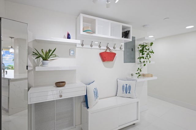 mudroom featuring electric panel and light tile patterned floors