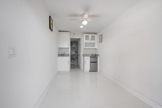 interior space featuring light tile patterned flooring and ceiling fan