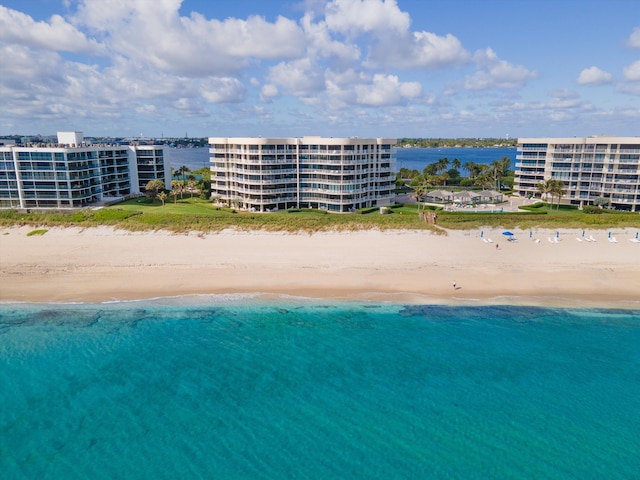 birds eye view of property featuring a beach view and a water view