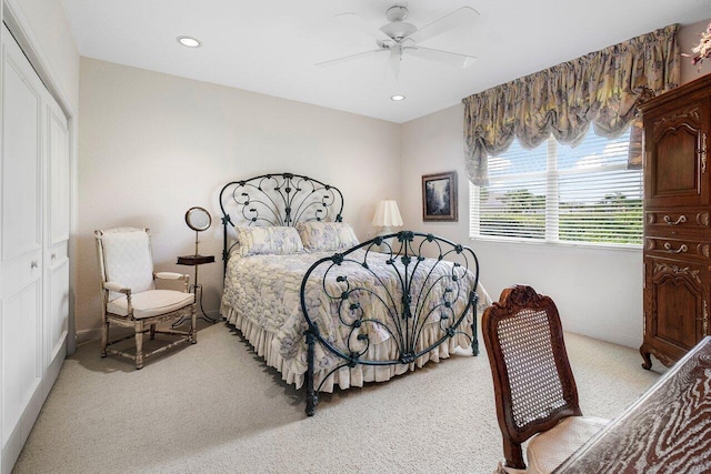 carpeted bedroom with ceiling fan and a closet