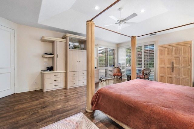 bedroom featuring a tray ceiling, ceiling fan, dark hardwood / wood-style flooring, and vaulted ceiling