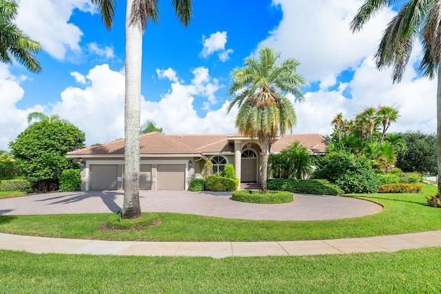 mediterranean / spanish-style house featuring a front yard