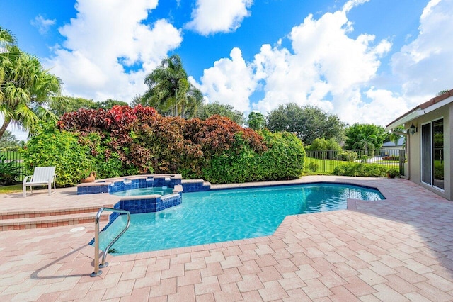 view of pool with a patio and an in ground hot tub