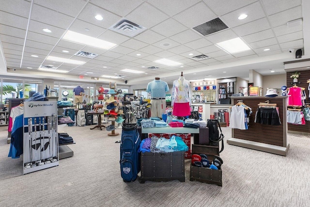 workout area featuring a paneled ceiling and carpet flooring