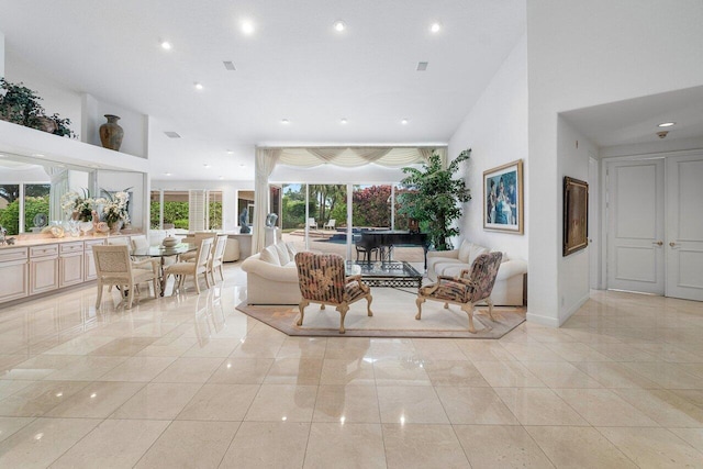 living room featuring a towering ceiling